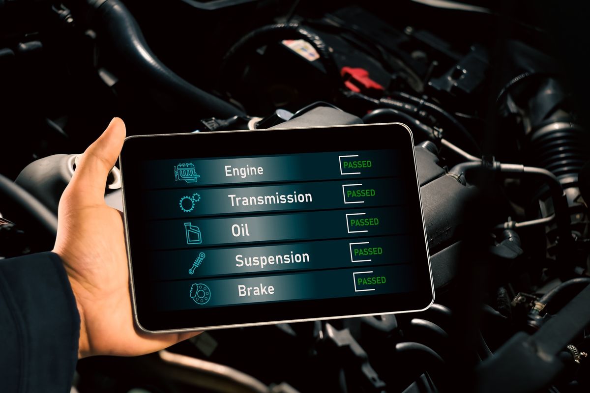 Technician performing OBD-II emissions test